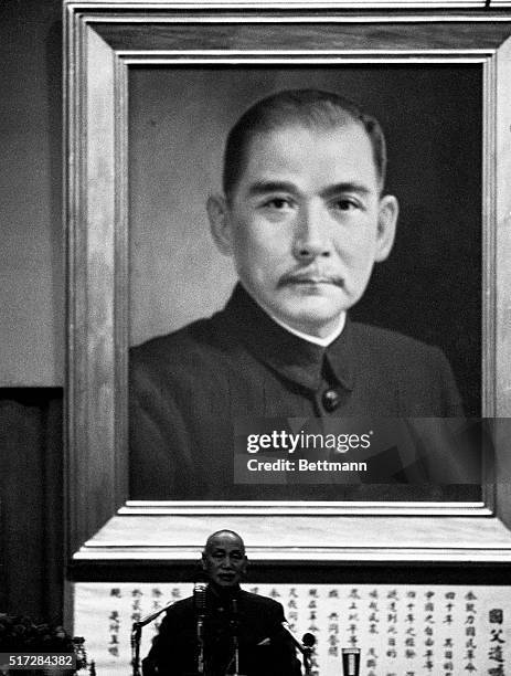 Nationalist Chinese president Chiang Kai-Shek appears dwarfed by a mammoth picture of the father of Chinese Democracy, Dr. Sun Yat-Sen, as he speaks...