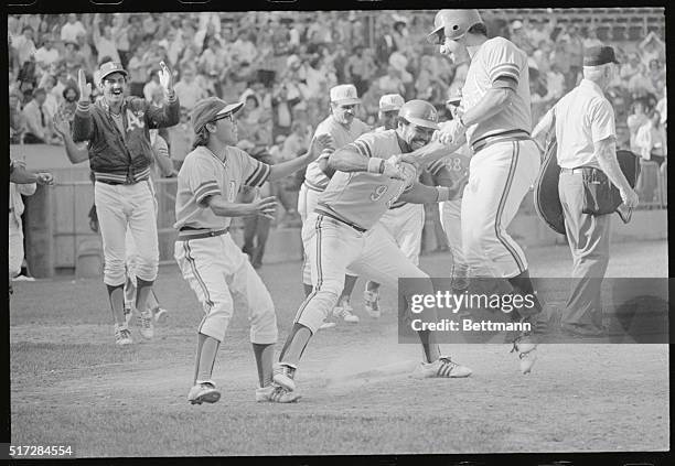 Oakland, Calif.: Oakland Athletics' infielder Sal Bando goes right up in the air after he scored the winning run to give the A's their second...