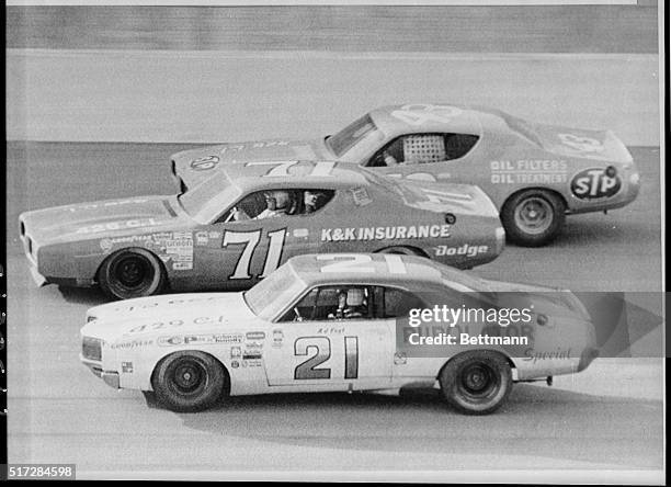 Foyt , Buddy Baker and Richard Petty race three abreast on the Banked oval of Texas World Speedway as they try for the lead of the 11/12 Texas 500....