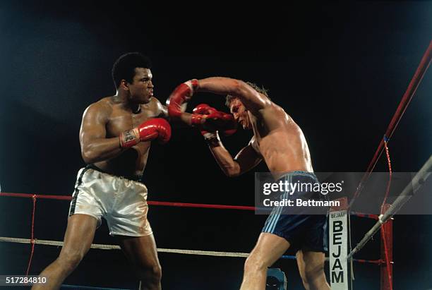 American boxer Muhammad Ali and British boxer Joe Bugner fighting a match. Ali won the 12-round fight in 1975.