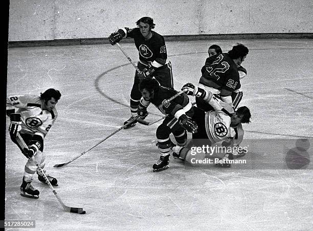 Bruins' Bobby Orr lands on the ice trying to penetrate the Islanders' defense by Gerry Hart and Bob Cook of New York during first period action....