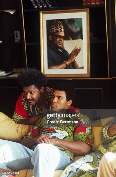 Boxer Muhammad Ali and fight promoter Don King in Ali's villa with a portrait of Mobutu on the wall behind them.