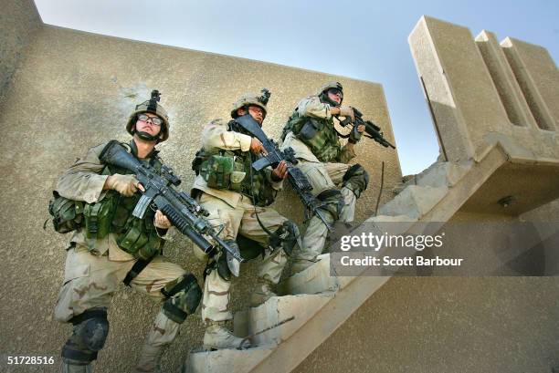 Army soldiers from the 1st Infantry Division's 2nd Battalion-2nd Regiment clear abandoned houses of insurgent fighters November 10, 2004 during...