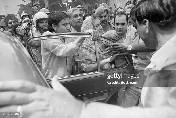 Former Indian Prime Minister Indira Gandhi and her son Sanjay Gandhi are escorted to her car, by friends and police men, after she was released by a...