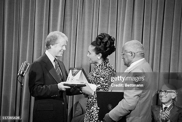 President Jimmy Carter presents the Medal of Freedom here to Coretta Scott King, accepting posthumously for her slain husband, Martin Luther King Jr,...