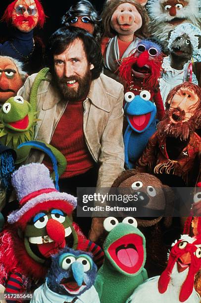 American puppeteer, creator of the Muppets and motion pictures, Jim Henson, poses with his creation characters in The Muppets TV show.