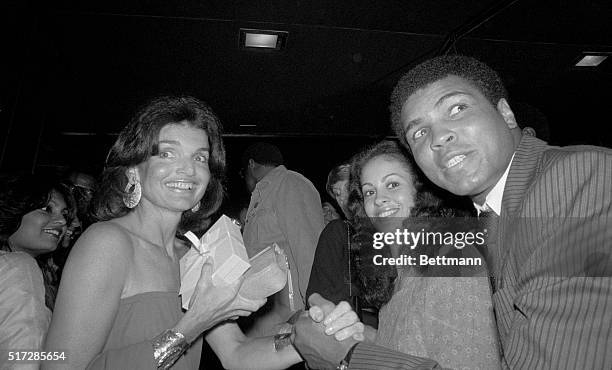 Jacqueline Kennedy Onassis greets world heavyweight boxing champ Muhammad Ali and his wife Veronica as they meet at a party at the Rainbow Room...