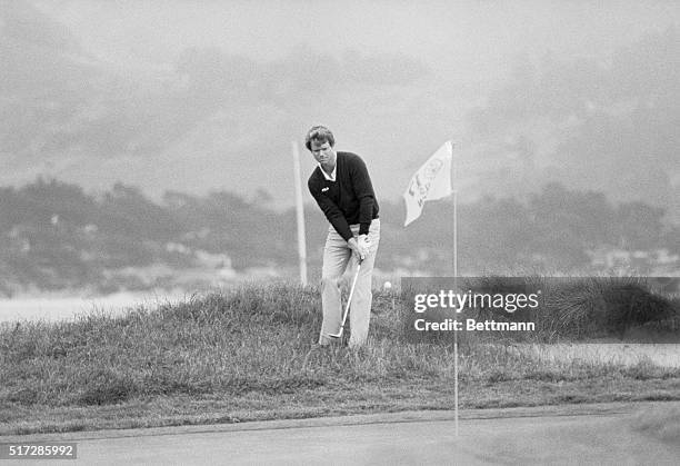 Pebble Beach, California: Tom Watson literally jumps for joy from the rough onto the 17th green, after he chipped in a birdie putt on the par 3 hole,...