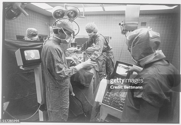 Chicago, Illinois: Dr. George Dohrmann , a neurosurgeon, holds a transducer, the scanning portion of the equipment, as he looks at nearby videoscreen...