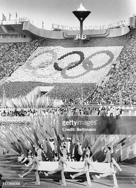 The Olympic flag is carried out of the Lenin Stadium at the closing ceremony of the 1980 Olympic Games here 8/3. The Olympic flame was extinguished...