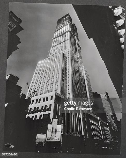 Representative of things modern is the Empire State Building, being erected on the site of the old Waldorf Astoria, captured here by the camera from...