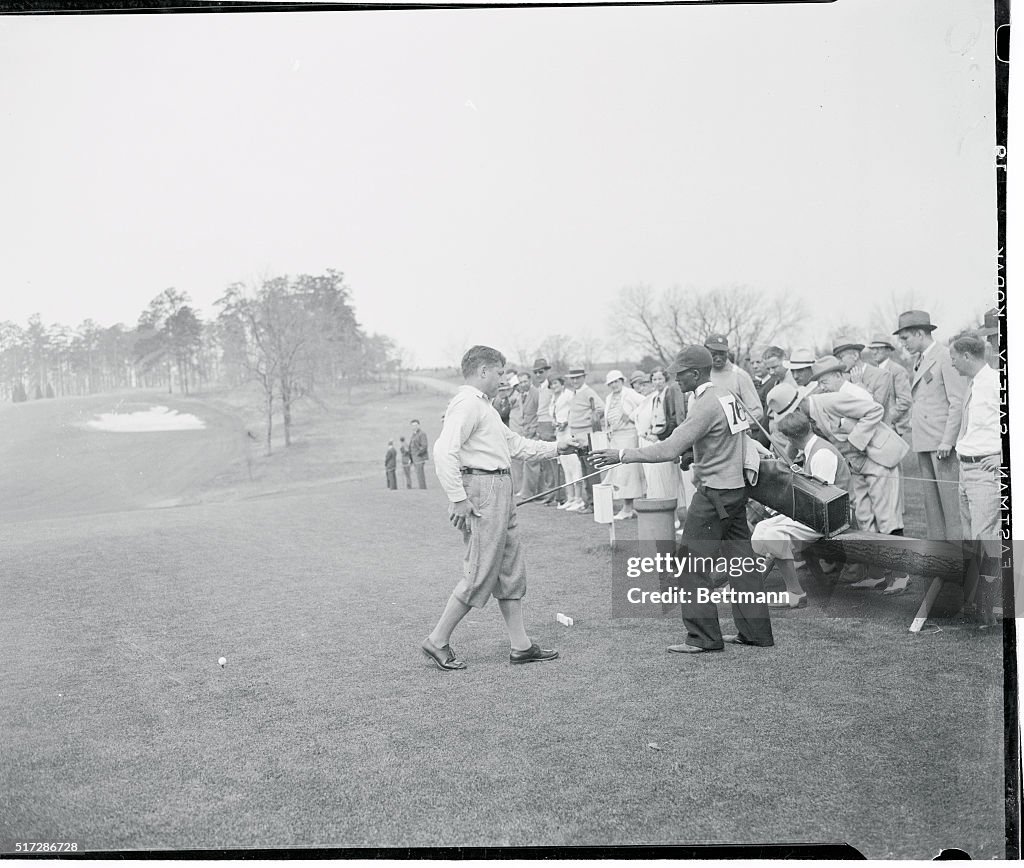 Bobby Jones Handing a Drink to His Caddy