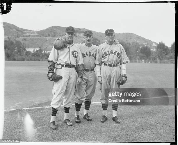 Larry French and Fred Lindstrom, former members of the Pittsburgh Pirates, are shown above with manager Charlie Grimm, of the Chicago Cubs, at...