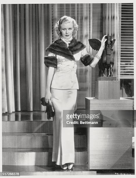 For evenings...This stunning formal evening suit is worn by Ginger Rogers, scintillating young RKO dancing star. The suit which is never worn without...