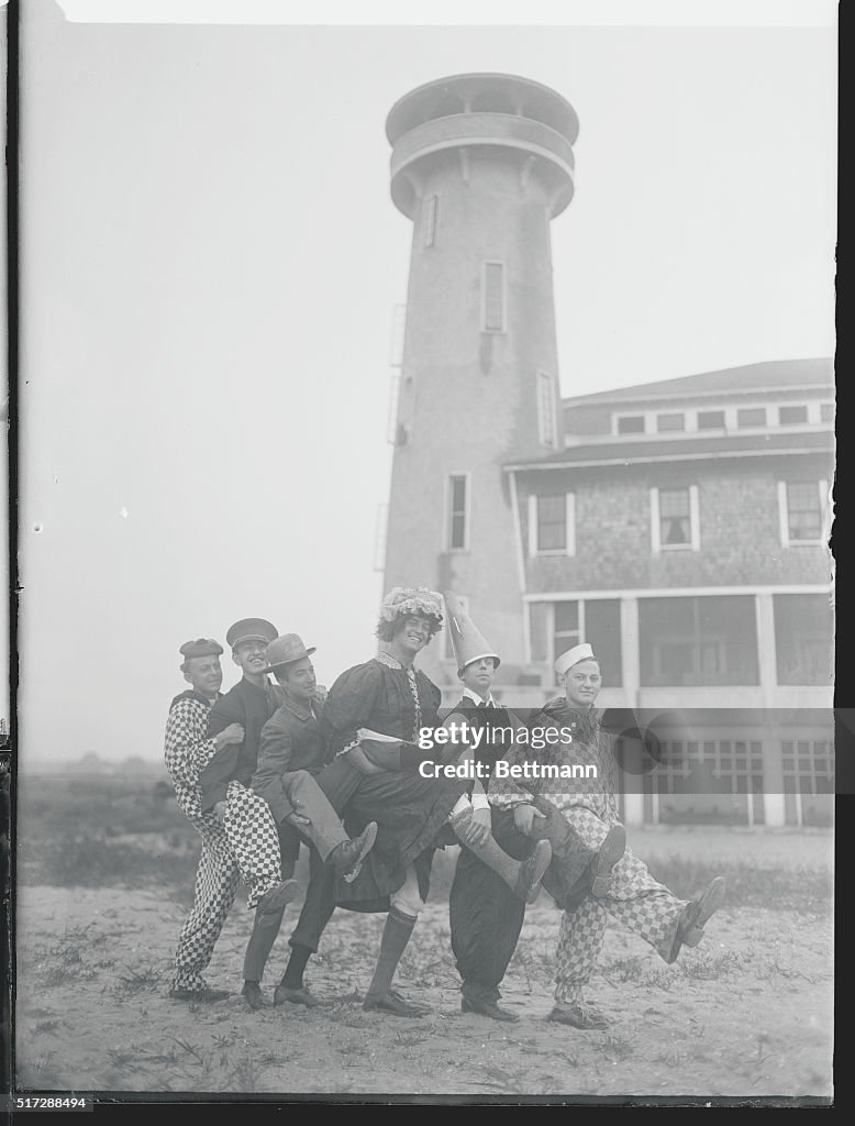 Actors Performing Near Lighthouse