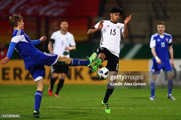 Mahmoud Dahoud of Germany is challenged by Andrias Eriksen of Faroe Islands during the 2017 UEFA European U21 Championships qualifier match between...