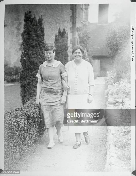 London:The Viscountess Rhondda at Home. Above at right is shown the Viscountess Rhondda, enjoying a walk about the garden of her country place at...