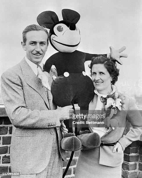 Walt Disney, creator of the world-famous Mickey Mouse, is pictured with Mrs. Disney--who helped him invent his famous cartoon character--as they...