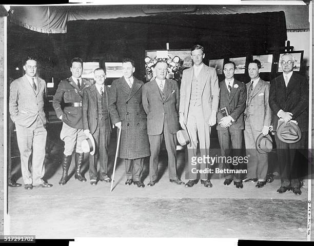 Heading a group of aviation notables, Col. Lindbergh visited Detroit's great aircraft show. Left t right B.F. Maroney, builder of Lindy's plane,...