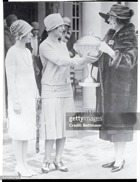 Helen Wills, famous Berkeley California tennis champion, is awarded with the William Randolph Hearst popularity trophy through a National Poll...