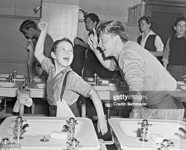 Mickey Rooney and Bobs Watson are shown here in this scene from Men of Boys Town "shaking a mean finger." It is a Metro Goldwyn Mayer film, also...