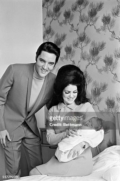Elvis Presley with Priscilla and their four day old daughter Lisa Marie prepare to leave Baptist Hospital in Memphis, Tennessee.