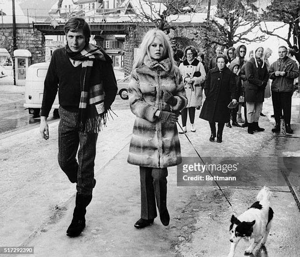 Gstaad, Switzerland: French actress Brigitte Bardot and her husband, Gunther Sachs, walk their dog through the streets of Gstaad watched by curious...