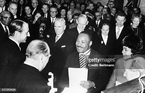 Crown Prince Harald and King Olav of Norway congratulate American civil rights activist Martin Luther King Jr. After he receives the Nobel Peace...