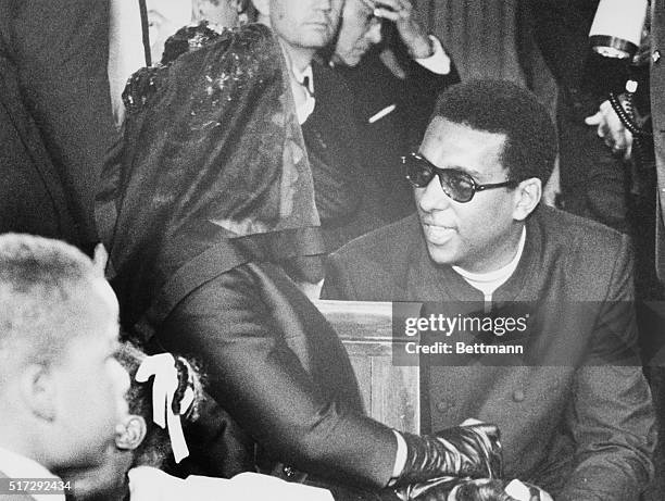 Stokely Carmichael talks with the widow of slain civil rights leader Dr. Martin Luther King Jr. At funeral services in Dr. King's Ebenezer Baptist...