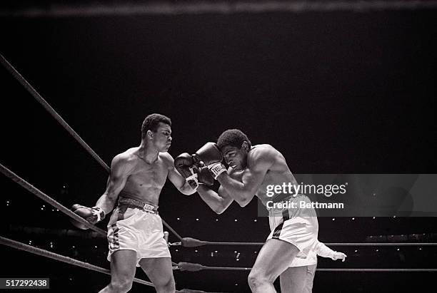 Cassius Clay punches challenger Ernie Terrell in the third round of their heavyweight championship fight at Houston's Astrodome in 1967. Clay won the...