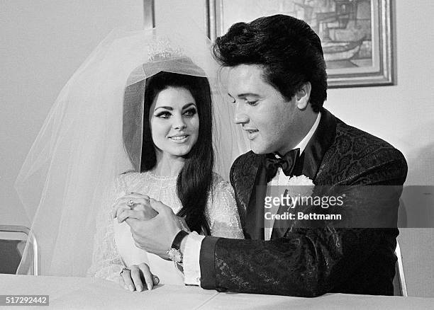 Elvis Presley shows off his wife Princilla's three-carat diamond wedding ring on their wedding day in Las Vegas.