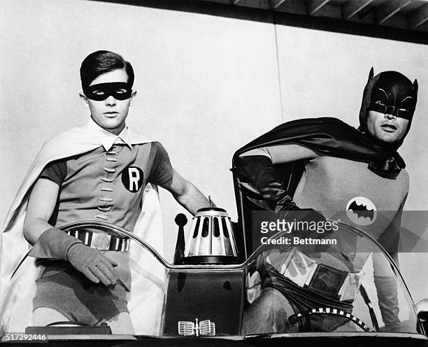 Adam West and Burt Ward as Batman and Robin atop the Batmobile, in the famously campy TV series "Batman".
