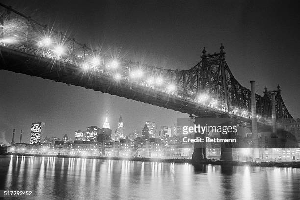 New York:Manhattan's bright lights reflect on the East River below the Queensboro Bridge. It was a year ago, Nov. 9, when this scene was darkened by...