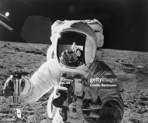 Apollo 12 astronaut Alan Bean's face mask reflects the Apollo 12 astronaut Commander Charles "Pete" Conrad, as Conrad snaps his companion's photo...