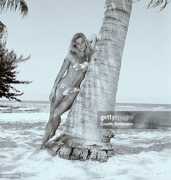 JAMAICA, WEST INDIES: CLAD IN A BIKINI, ACTRESS YVETTE MIMIEUX FINDS THE TRUNK OF A PALM TREE A PERFECT RESTING SPOT IN THE SHADE. YVETTE FOUND TIME...