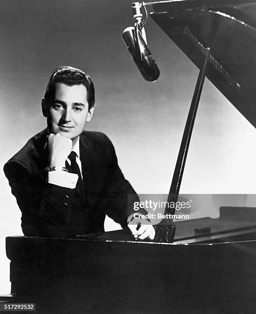 Portrait of singer Neil Sedaka at a grand piano.