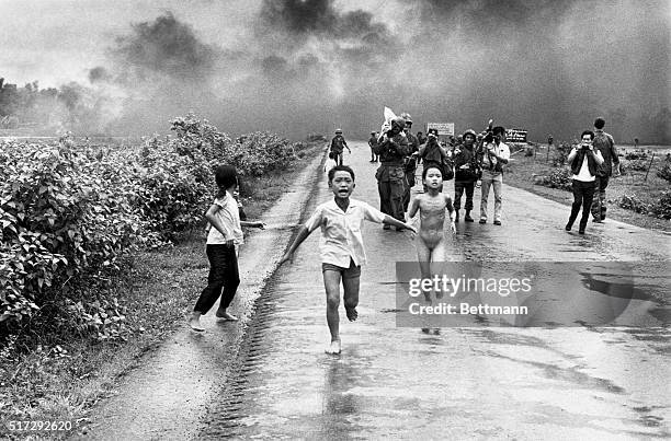 Vietnamese children flee from their homes in the South Vietnamese village of Trang Bang after South Vietnamese planes accidently dropped a napalm...