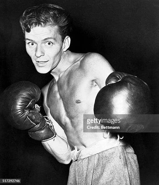 The young Frank Sinatra poses in boxing gloves for a publicity shot. In April of the same year, Sinatra, whose reputation included the occasional...