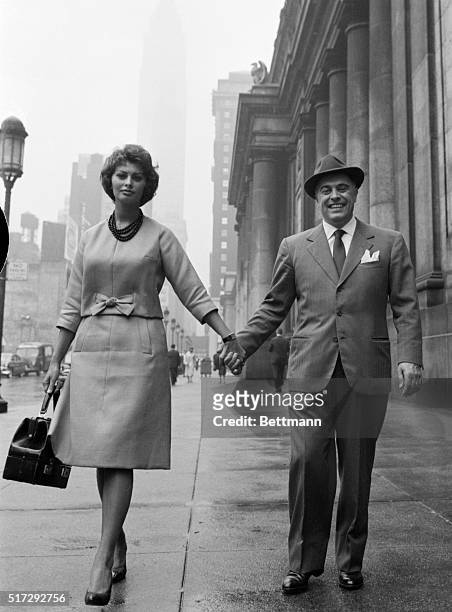 New York: Hand-in-hand, actress Sophia Loren and her husband Carlo Ponti stroll outside Penn Station here June 9th. Miss Loren is making her first...