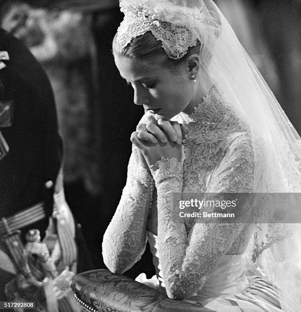 Grace Kelly prays during her wedding to Prince Rainier of Monaco on April 20, 1956.