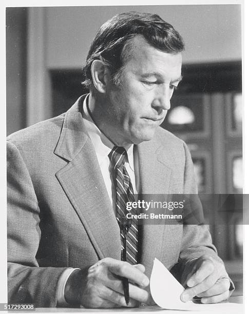 Nightly News anchor Roger Mudd reviews his notes.