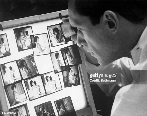 Hugh Hefner who launched one of the most controversial magazines in publishing history, views photographs in his Chicago office.