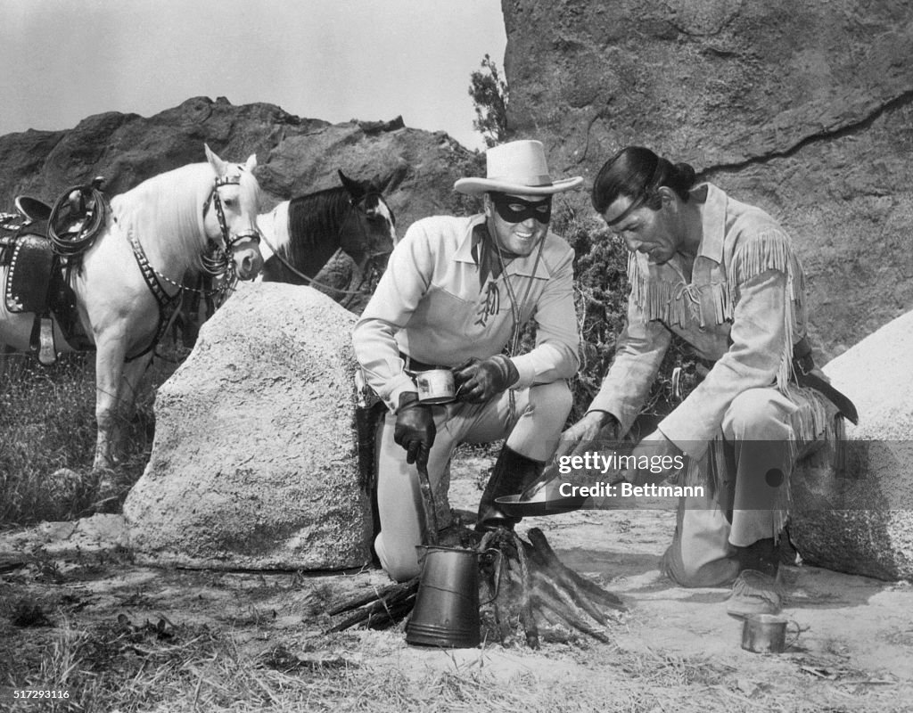 Lone Ranger and Tonto Characters Cooking Food over Camp Fire