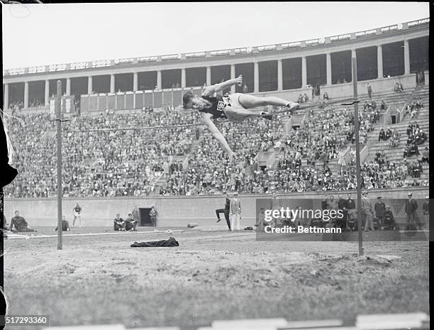 Cambridge, Mass.: Duncan McNaughton of the University of Southern California, Olympic champion, leaps over the bar for the fourth time in the high...