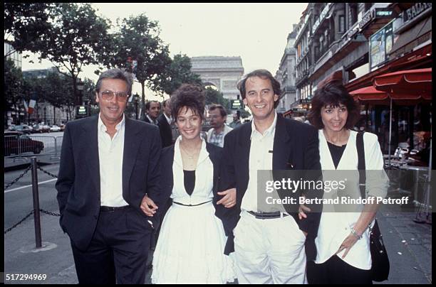 Alain Delon, Marie, Michel Fugain and his wife Stephanie on the Champs Elysees for the premiere of the movie "Thank You Satan".