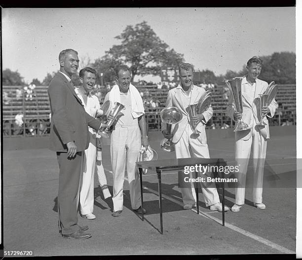 John Van Ryn and Wilmer Allison, winners, and Gene Mako and Donald Budge, runners up , snapped receiving the National Doubles tennis championship...