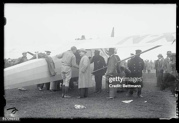 Captain Charles Lindbergh is shown wit B. J. Mahoney, loading his plane before his hop off to Paris.
