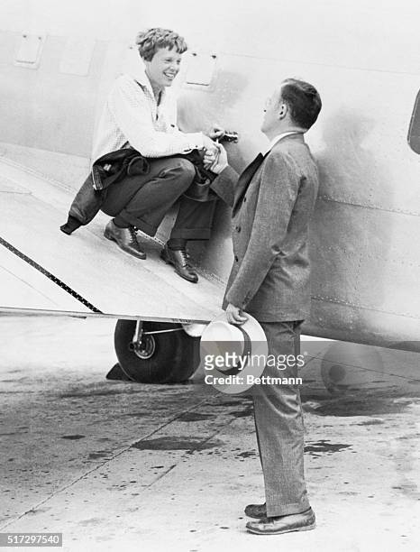 Amelia Earhart saying goodbye to her husband, George P. Putnam, at Miami, Florida, June 1st, just before she took off with Captain Fred Noonan for...
