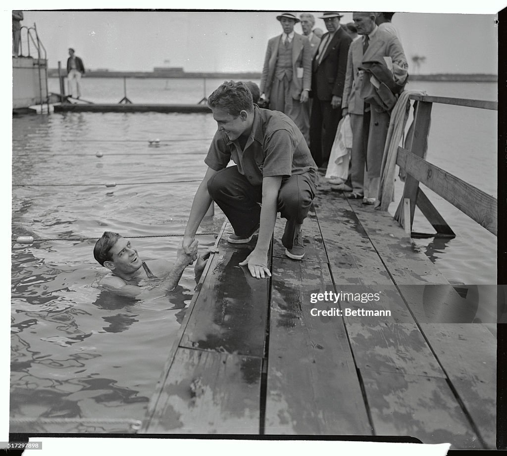 Ralph Flanagan in Pool Shaking Hands with Adolph Kiefer