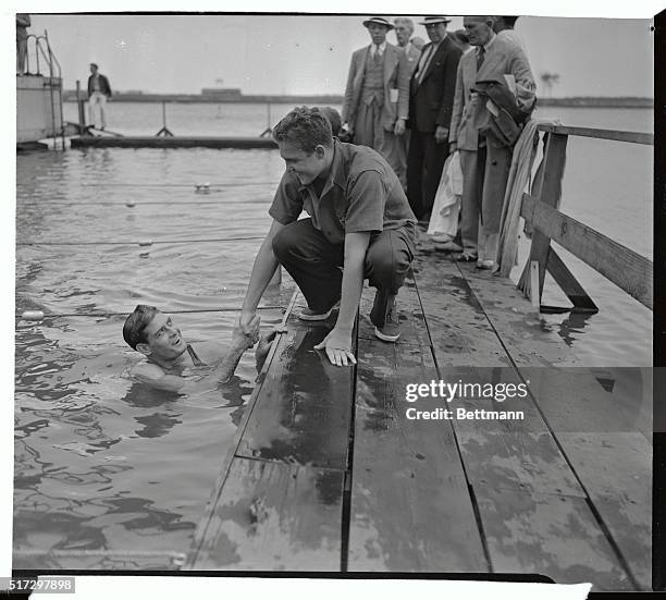 Ralph Flanagan, of Miami, Florida, having smashed four world's records in the mile swim on the opening day of the Men's NAAU Swimming Meet in...